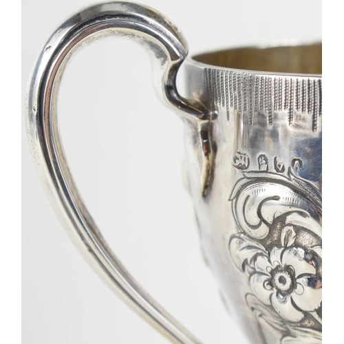 329 - A George II, Irish silver twin handled trophy, vacant cartouche and embosed with foliate decoration,... 