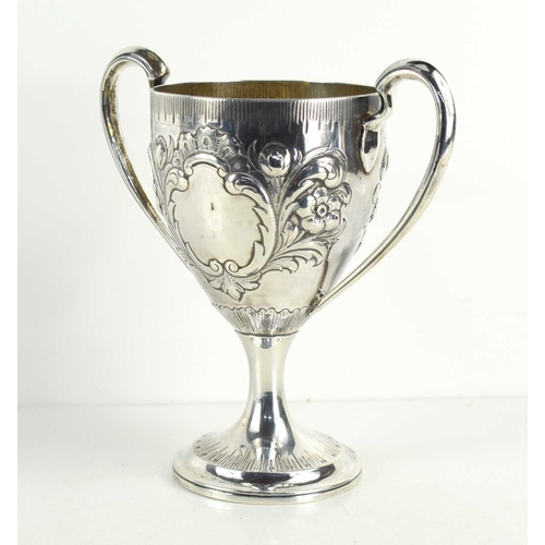 329 - A George II, Irish silver twin handled trophy, vacant cartouche and embosed with foliate decoration,... 