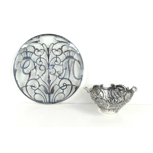 341 - A silver Bon Bon dish with scrolling rim and embossed with flowers, scroll work and geometric patter... 