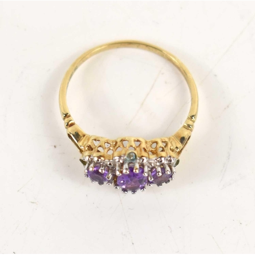 35 - A 9ct gold and amethyst ring, the three oval graduated amethysts in platinum claw setting on yellow ... 