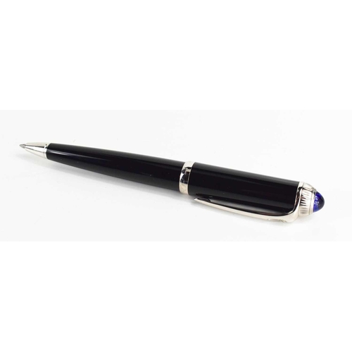 57 - A Cartier ballpoint pen, black composite body and cap, palladium-finish details, blue resin cabochon... 