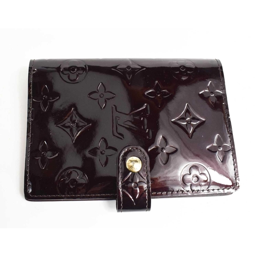 58 - A Louis Vuitton patent leather deep burgundy wallet / purse, with button clasp.