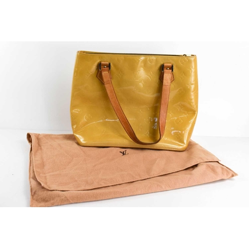 62 - A Louis Vuitton gold coloured patent leather handbag, 31cm.