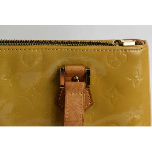 62 - A Louis Vuitton gold coloured patent leather handbag, 31cm.