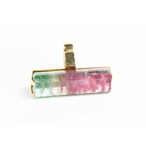 7 - A 9ct gold and watermelon tourmaline cocktail dress ring, the large and impressive baguette cut ston... 