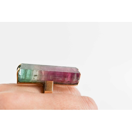 7 - A 9ct gold and watermelon tourmaline cocktail dress ring, the large and impressive baguette cut ston... 