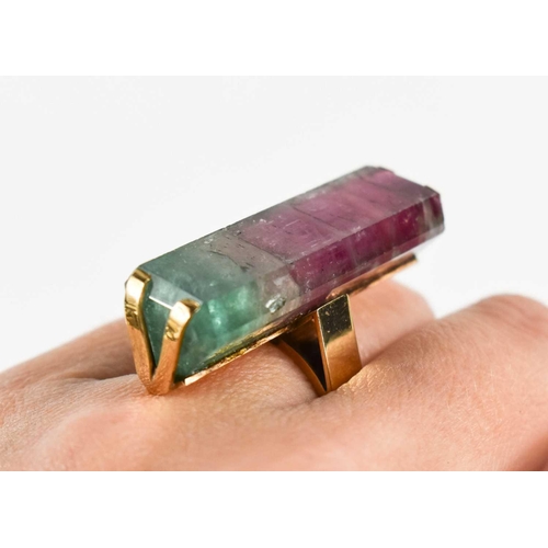 7 - A 9ct gold and watermelon tourmaline cocktail dress ring, the large and impressive baguette cut ston... 