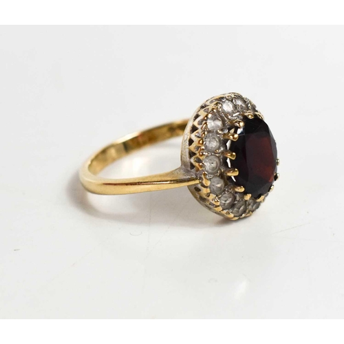 72 - A 9ct gold, garnet and cubic zirconia dress ring, size P, 4.1g.