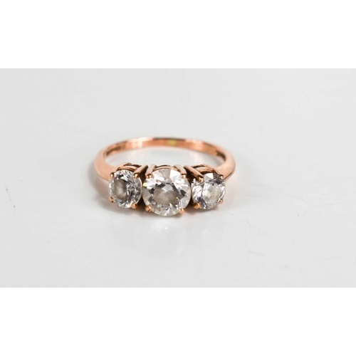 77 - A 14ct rose gold and cubic zirconia three stone dress ring, size L, 2.8g.