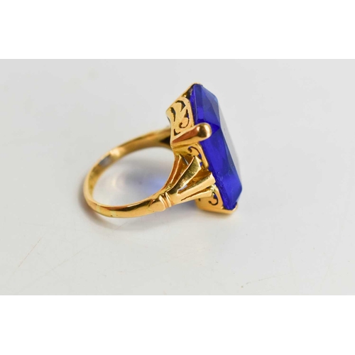 8 - A 22ct gold and paste cocktail dress ring, set with large emerald cut deep cornflower blue paste sto... 