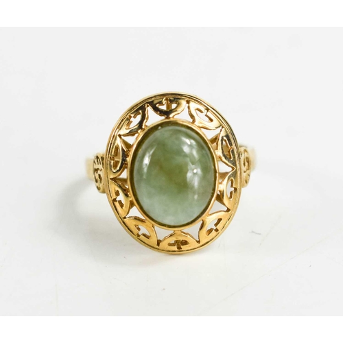 91 - A 9ct gold and jade ring, the oval jade cabochon set in an open work border, with two calligraphy ma... 