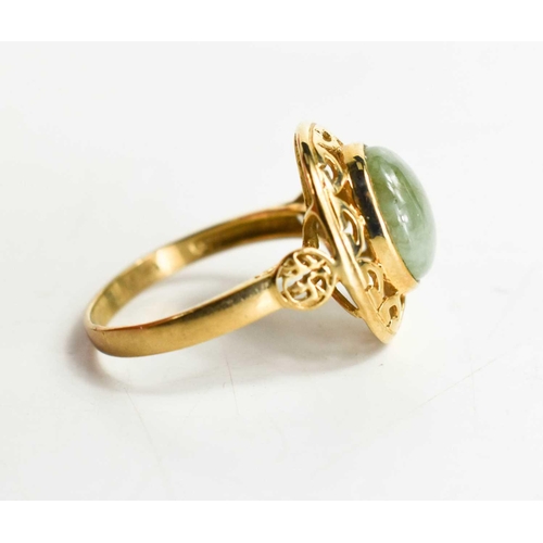 91 - A 9ct gold and jade ring, the oval jade cabochon set in an open work border, with two calligraphy ma... 