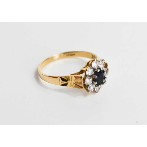 98 - A 9ct gold, diamond and sapphire ring, of flowerhead form, size O, 2.1g.