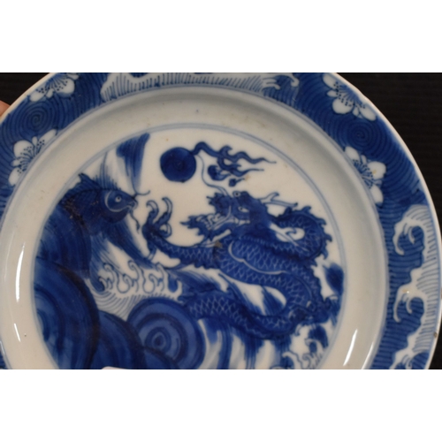 31 - A 19th century Qing period blue and white Chinese dish, depicting a dragon chasing a flaming pearl, ... 