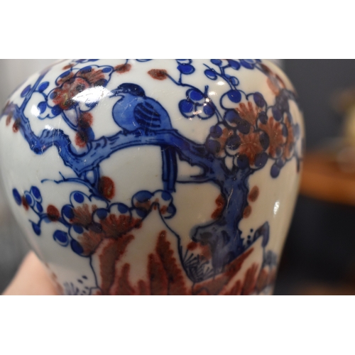 66 - A Chinese bottle vase, in blue, red and white, depicting a bird perched in a prunus blossom tree, tw... 