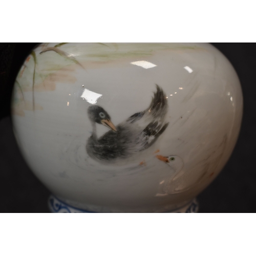 35 - A 20th century Chinese bottle vase, in underglaze blue and white, and overglazed hand painted ducks ... 