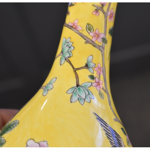 131 - A pair of Chinese cloisonne vases, the yellow ground with birds amongst tree peonies, chrysanthemums... 