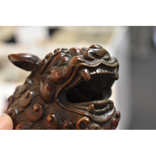 111 - An early bronze dog of fo, with red patination, with impressed calligraphy mark to the underside, mo... 