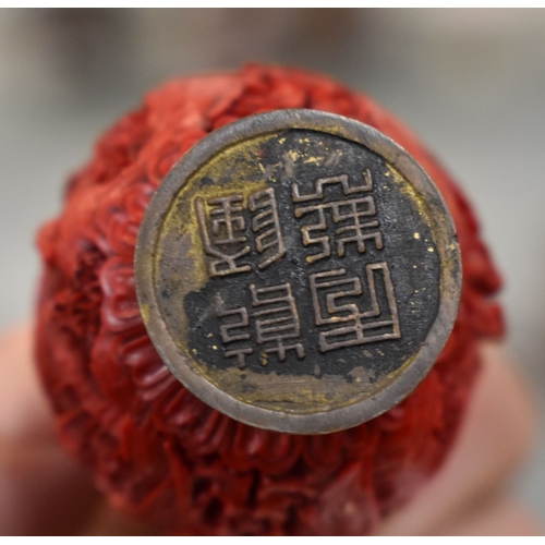 129 - A small Chinese cinnabar snuff bottle, character mark to the base together with a enamel and cinnaba... 