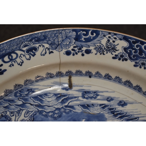 33 - An early 19th century Chinese blue and white charger, depicting a figure standing beside a tree with... 