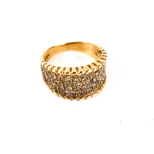 105 - A 9ct gold and diamond modernist dress ring, the wide band studded with diamonds, with scalloped edg... 