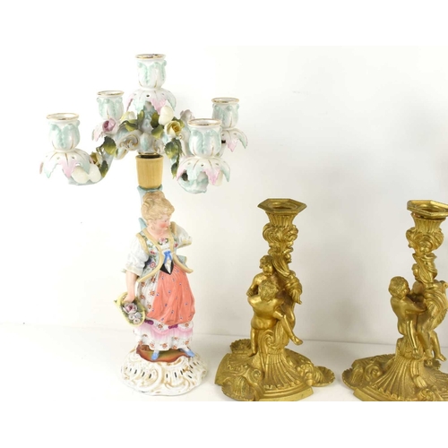 196 - A pair of French style gilt metal candlesticks with cherubs modelled to the centre together with a p... 