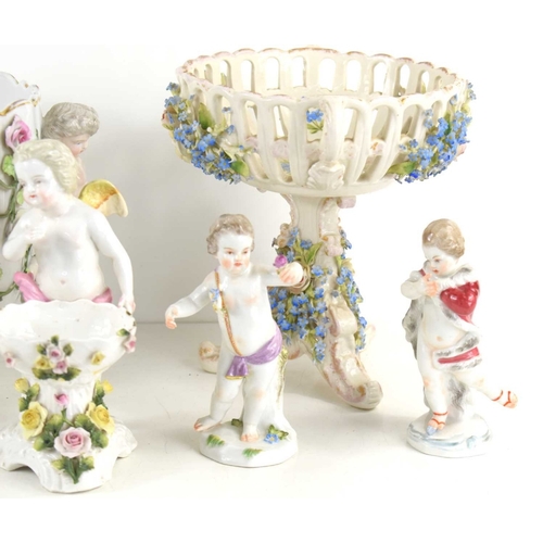 197 - A group of cherub figurines to include example by Meissen together with a 19th century floral basket... 