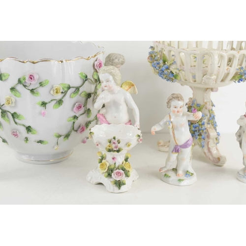 197 - A group of cherub figurines to include example by Meissen together with a 19th century floral basket... 