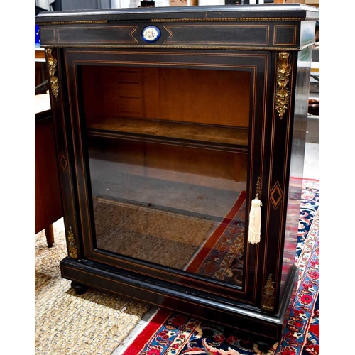 451 - A Victorian ebonised pier cabinet, with glazed door enclosing shelves on a plinth base, 87cm by 35 b... 