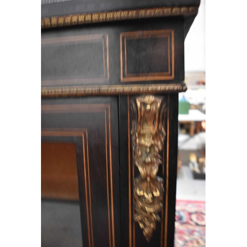 451 - A Victorian ebonised pier cabinet, with glazed door enclosing shelves on a plinth base, 87cm by 35 b... 