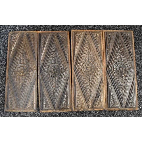 455 - A set of four 18th century oak carved panels, carved with diamonds centred by flowerheads, each 49cm... 