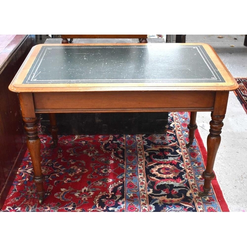 457 - A Victorian mahogany ladies writing table with green leather top, the turned legs raised on brass ca... 