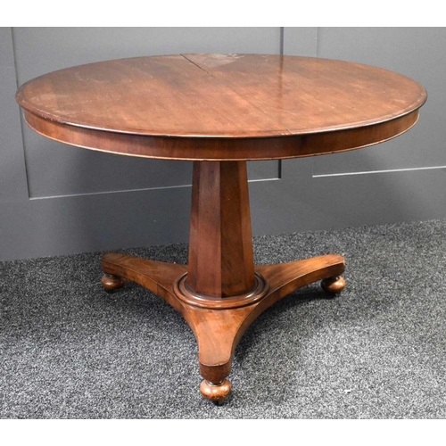 460 - A Victorian mahogany circular top centre table with tilt top, raised on octagonal tapered base and r... 