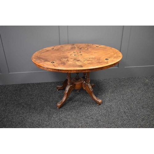 467 - A Victorian walnut marquetry inlaid breakfast table raised on four turned columns united by a centra... 