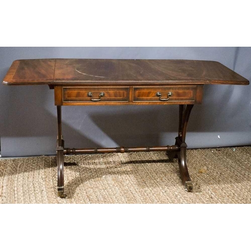 476 - A mahogany sofa table, with crossbanding and stringing to the top, above two drawers, raised on twin... 