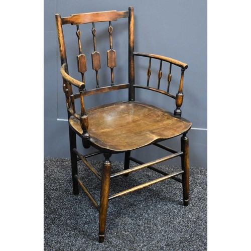 486 - A 19th century country oak armchair, with spindled back and arms, shaped slab seat, and legs united ... 