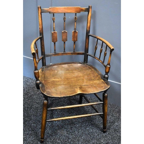 486 - A 19th century country oak armchair, with spindled back and arms, shaped slab seat, and legs united ... 