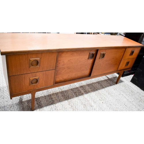 488 - A vintage 1960's teak sideboard with two drawers to either side of double cupboard doors raised on t... 