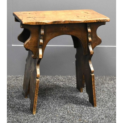 490 - A 16th century style boarded oak stool, with shaped end and side boards, plank top, carved with cros... 