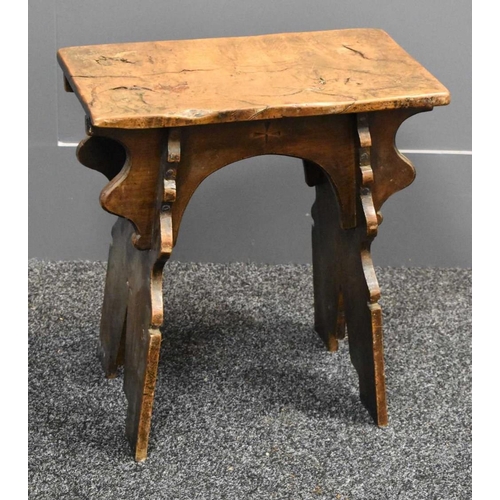 490 - A 16th century style boarded oak stool, with shaped end and side boards, plank top, carved with cros... 