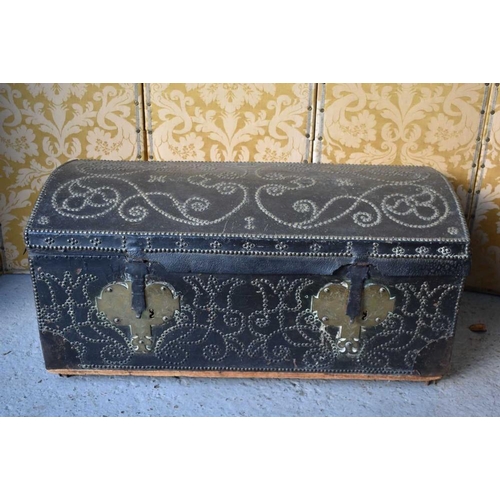 493 - A 17th century Anglo-Dutch leather clad studwork chest, with domed top decorated with scrolling stud... 