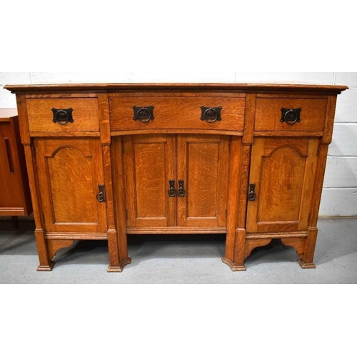 496 - An early 20th century Arts and Crafts oak dresser, with reverse bow top, fitted with three drawers a... 