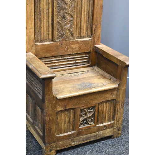 498 - A 16th century French oak throne chair, with 19th century restorations, the tall back having lobed f... 