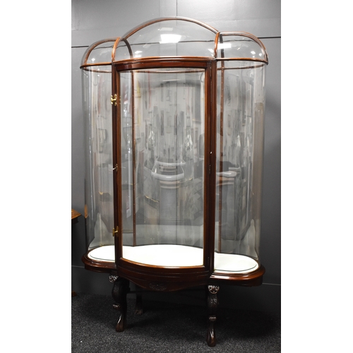 500 - An unusual and impressive mahogany and glass display cabinet, with triple domed top and curved ends,... 