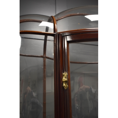 500 - An unusual and impressive mahogany and glass display cabinet, with triple domed top and curved ends,... 