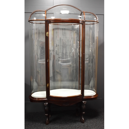 500 - An unusual and impressive mahogany and glass display cabinet, with triple domed top and curved ends,... 