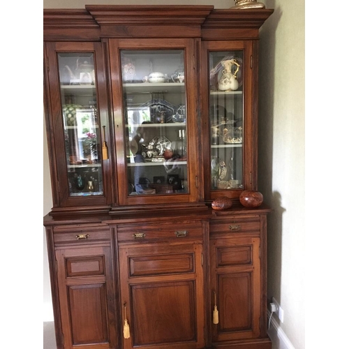 483 - A Victorian Indian rosewood breakfront bookcase, fitted with three cupboards, three drawers and glaz... 