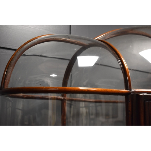 500 - An unusual and impressive mahogany and glass display cabinet, with triple domed top and curved ends,... 