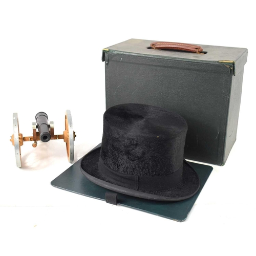 112 - A vintage silk top hat by Austin Reed with box together with a model cannon.