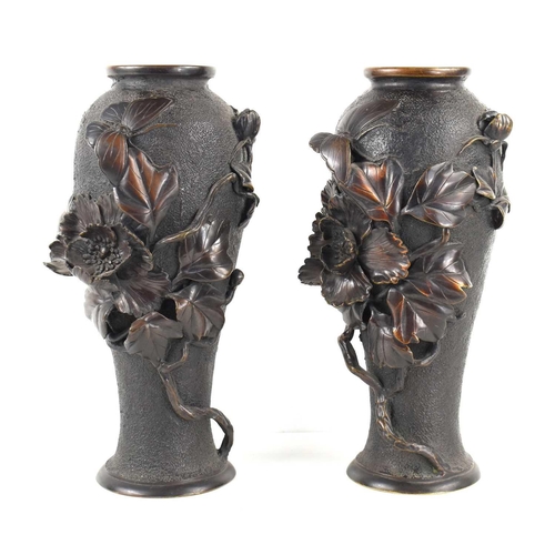 119 - A pair of Japanese bronze vases, with relief decoration depicting a butterfly among a sprays of flow... 